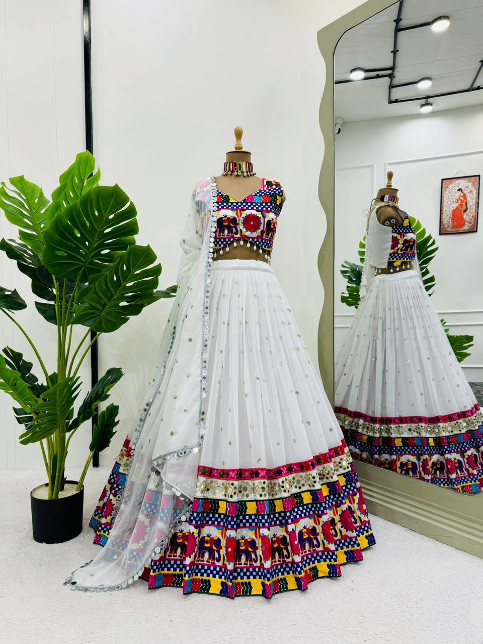 Exquisite Pristine White Designer Lehenga Choli with Vibrant Multicolored Traditional Elephant Embroidery and Mirror Work Detailing